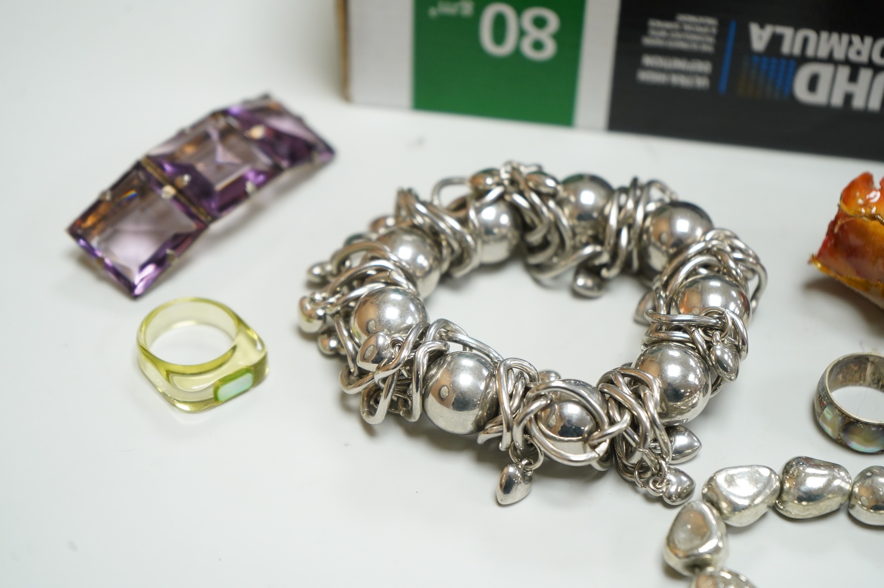 A collection of assorted costume jewellery, including a pair of spherical amethyst drop earrings, a modern silver mounted aide memoire, brooches, necklaces, rings et.